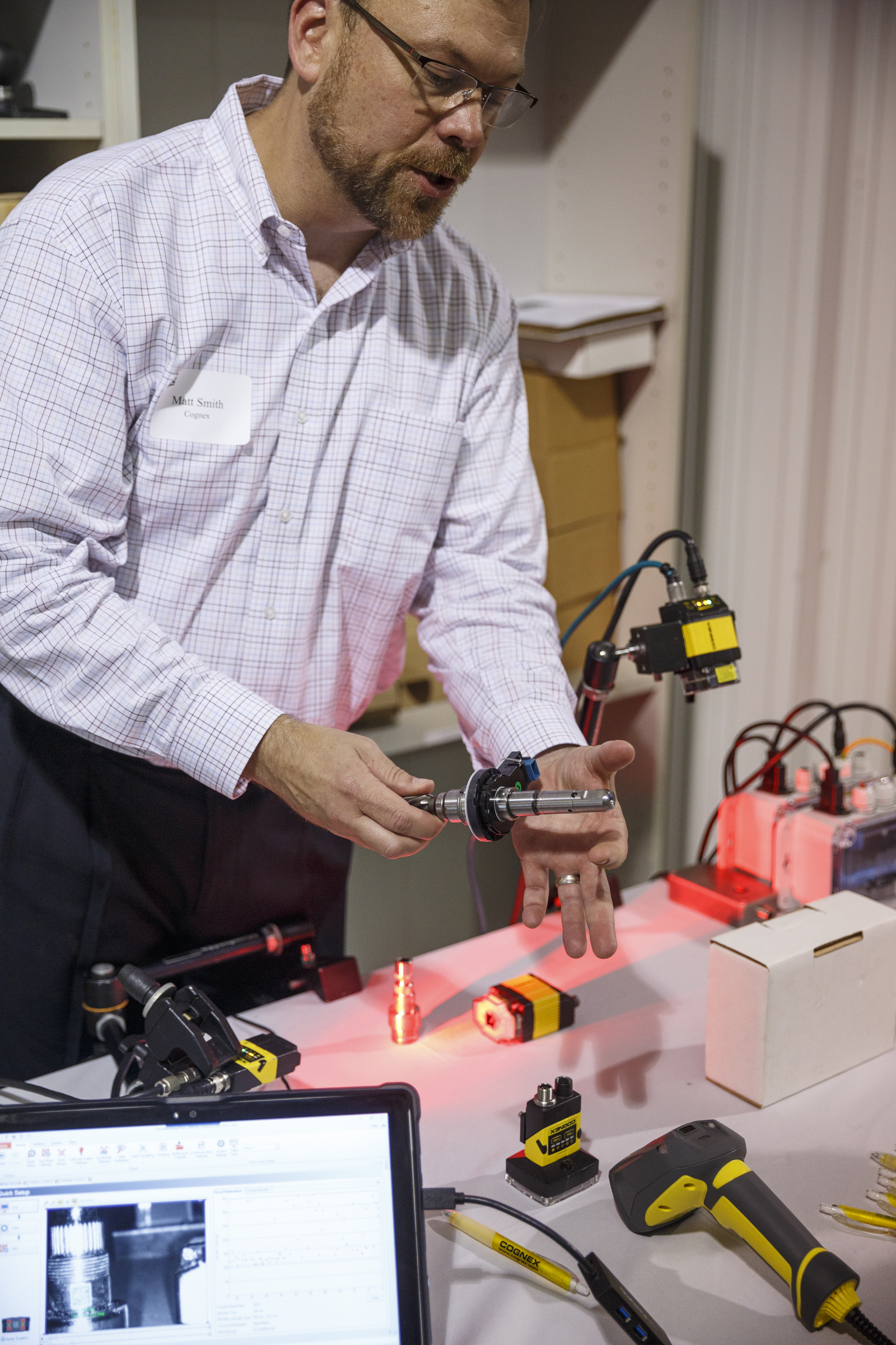 Matt Smith talks about industrial barcode scanners during an open house at the company Barcom on Thursday, May 12, 2016, in Chattanooga, Tenn. The business, which makes equipment for managing and scanning bar codes, is celebrating its 25th year.