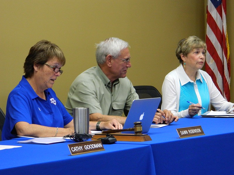 PHOTO BY PAUL LEACH Cleveland school board members Dawn Robinson, left, Murl Dirksen and Peggy Pesterfield discuss school director search candidates.
