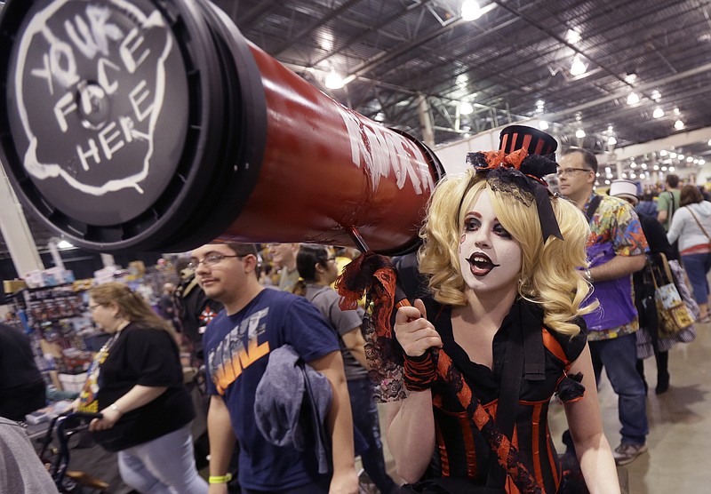 
              Jordan Davis, who came dressed as "Batman" villain Harley Quinn, said she was stopped 15 times to pose for pictures within the first 20 minutes of the Motor City Comic Con, Friday, May 13, 2016 in Novi, Mich. Tens of thousands of fans are expected at the 27th annual convention which got underway Friday. The three-day pop-culture extravaganza welcomes dozens of celebrities from TV and film as well as hundreds of comic book creators, writers and artists. (AP Photo/Carlos Osorio)
            
