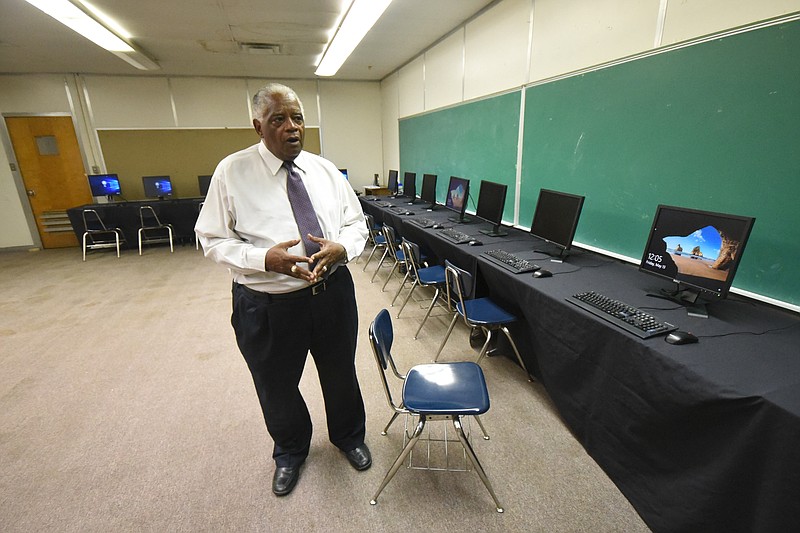 George Calhoun, president of the Alton Park Development Corporation, talks about the 15 computers and free Wifi donated by EPB for the new Chattanooga Civic Center on Friday inside the old Piney Woods Elementary School.