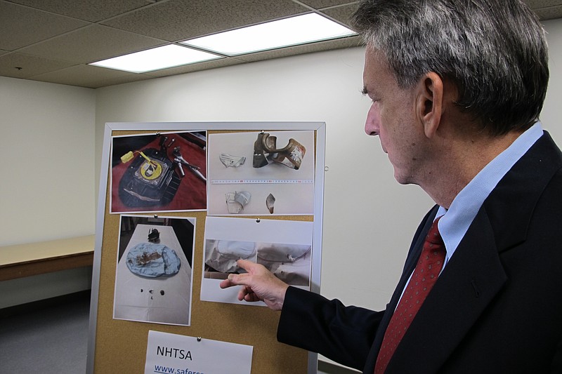 
              Stephen Levins, executive director of the Hawaii Office of Consumer Protection, shows photos of defective air bags and parts on Friday, May 13, 2016 in Honolulu. The state of Hawaii is suing Japanese manufacturer Takata over defective air bags they say threaten peoples’ lives. (AP Photo/Cathy Bussewitz)
            