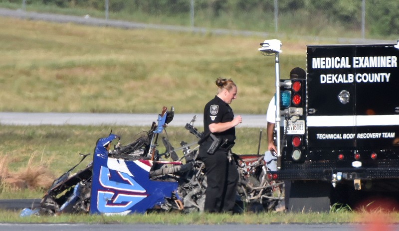 Authorities investigate the site of a small plane crash at DeKalb Peachtree Airport on Saturday, May 14, 2016, near the end of the Good Neighbor Day Air Show. (Hyosub Shin/Atlanta Journal-Constitution via AP)