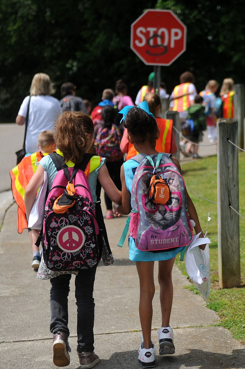 
              In this photo taken Wednesday, May 11, 2016, Christenberry Elementary School students take part in the Walking School Bus program in Knoxville, Tenn. The program helps children after school to walk safely to their guardians while also providing exercise. (Caitie McMekin/Knoxville News Sentinel, via AP)
            
