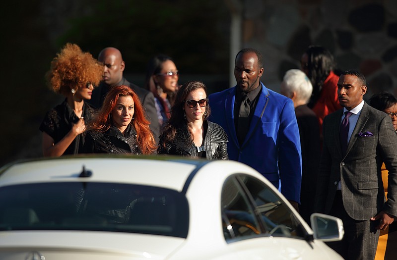 
              From left, Prince's personal assistant, Meron Bekure, 3rdEyeGirl bassist Ida Nielsen and guitarist Donna Grantis, former staffers Romeo and Mark Spark leave the Kingdom Hall following the memorial service for Prince, Sunday, May 15, 2016, in Minnetonka, Minn. Mourners gathered at a Jehovah's Witnesses Kingdom Hall for a memorial for megastar Prince, who worshipped there before he died last month. (Jeff Wheeler/Star Tribune via AP)  MANDATORY CREDIT; ST. PAUL PIONEER PRESS OUT; MAGS OUT; TWIN CITIES LOCAL TELEVISION OUT
            