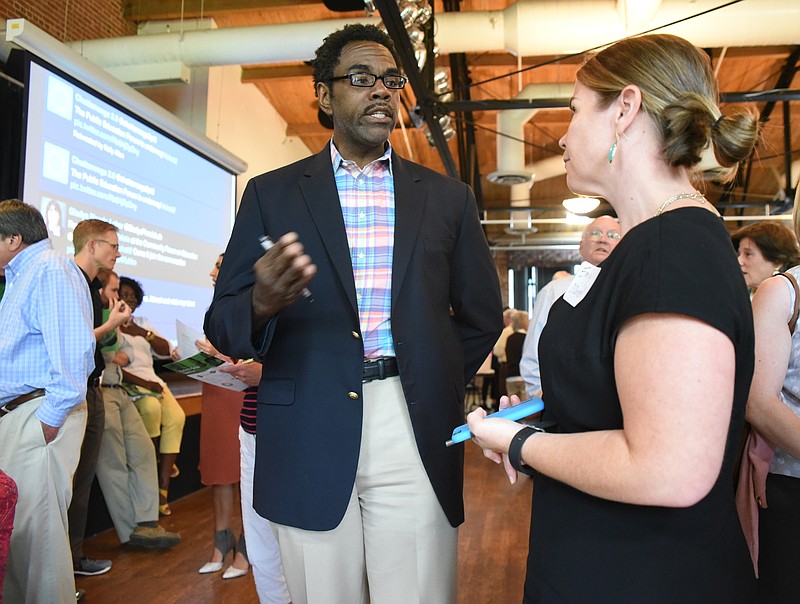 Ric Morris, center, talks with Emily O'Donnell on Monday at the Chattanooga 2.0 open house event held at the Bessie Smith Cultural Center. Morris is a 1980 Howard High School graduate, and received a Masters from Yale University. O'Donnell is vice president of external relations for the Public Education Foundation.