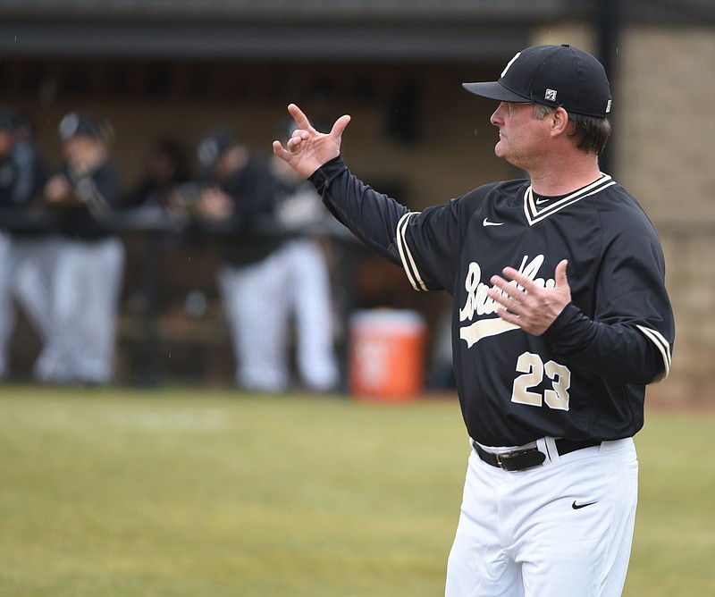 Bradley baseball coach Travis Adams talks to his players as Bradley Central wins 6-3 over Ooltewah in the season opening game for both teams Monday, Mar. 9, 2015, in Cleveland, Tenn.