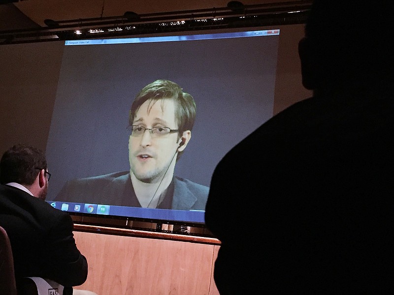 
              FILE- In this Feb. 17, 2016, file photo, former National Security Agency contractor Edward Snowden, center, speaks via video conference to people in the Johns Hopkins University auditorium in Baltimore. The Intercept, an online news site whose founding editors were the first to publish documents leaked by Snowden, released on Monday, May 16, the first batch of nine years' worth of the newsletters, which offer a behind-the-scenes glimpse into the NSA’s work. (AP Photo/Juliet Linderman, File)
            