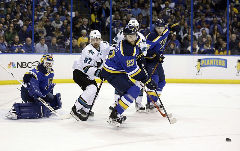 
              St. Louis Blues defenseman Alex Pietrangelo (27) chases the puck against San Jose Sharks right wing Joonas Donskoi (27) and center Tomas Hertl (48) during the first period in Game 2 of the NHL hockey Stanley Cup Western Conference finals, Tuesday, May 17, 2016, in St. Louis. (AP Photo/Jeff Roberson)
            