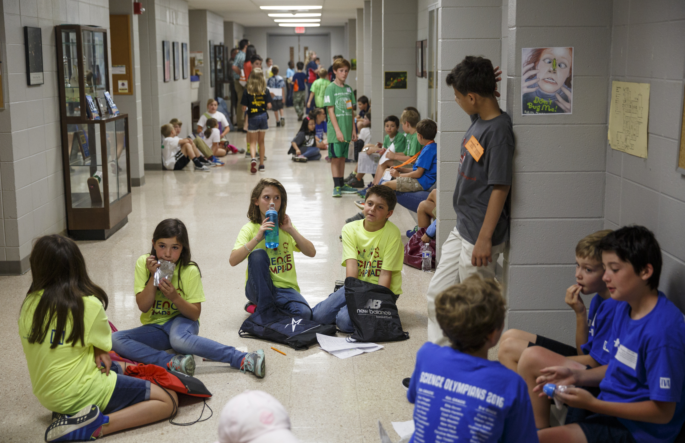 Students take a break in the hallway during the 10th annual regional Elementary Science Olympiad at Chattanooga State Technical Community College on Tuesday, May 17, 2016, in Chattanooga, Tenn. Hundreds of elementary students competed in science-based competitions that included egg drops, pressurized rockets, and bridge building.