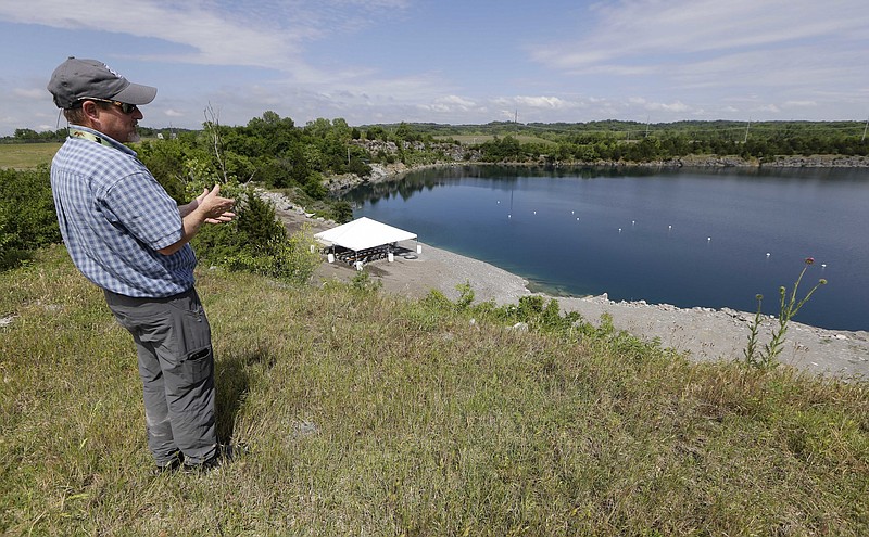 
              Bob Abbott, a construction inspector at the Nashville International Airport, looks over a quarry as he explains the process of a geothermal lake cooling system at the Nashville International Airport Tuesday, May 17, 2016, in Nashville, Tenn. The airport has begun using the abandoned quarry to halve its cooling costs by taking advantage of the reservoir's year-round 50-degree temperature. (AP Photo/Mark Humphrey)
            