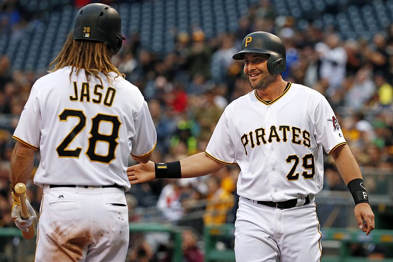 Pittsburgh Pirates' Francisco Cervelli (29) celebrates with teammate John Jaso (28) after scoring on a single by Pirates pitcher Juan Nicasio off Atlanta Braves pitcher Aaron Blair during the first inning of a baseball game in Pittsburgh, Tuesday, May 17, 2016.