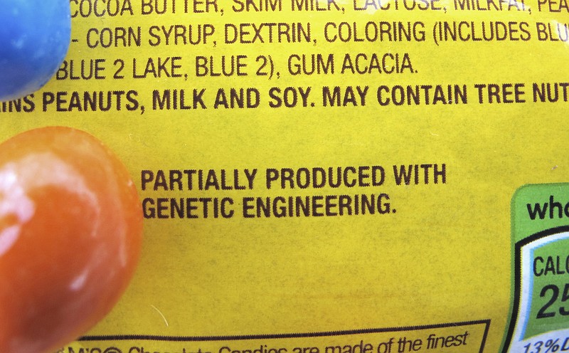 
              FILE - In this April 8, 2016 file photo, a new disclosure statement is displayed on a package of Peanut M&M's candy in Montpelier, Vt., saying they are "Partially produced with genetic engineering." Genetically manipulated food remains generally safe for humans and the environment, a high-powered science advisory board declared in a report Tuesday, May 17, 2016.  (AP Photo/Lisa Rathke, File)
            