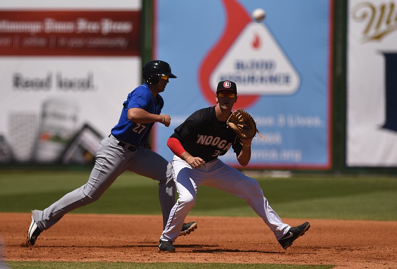 Chattanooga Lookouts' first baseman D.J. Hicks waits for the throw as the Biloxi Shuckers' Jacob Nottingham heads back for first on Sunday, May 15, 2016, at AT&T Stadium.