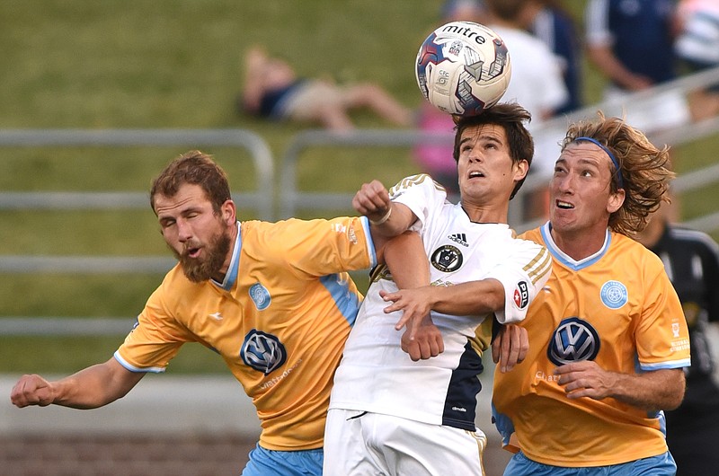 Chattanooga Football Club's John Davidson, left, and Juan Hernandez fight their way in as Reading United AC's Aguilar Calzada heads the ball Wednesday, May 18, 2016 at Finley Stadium.