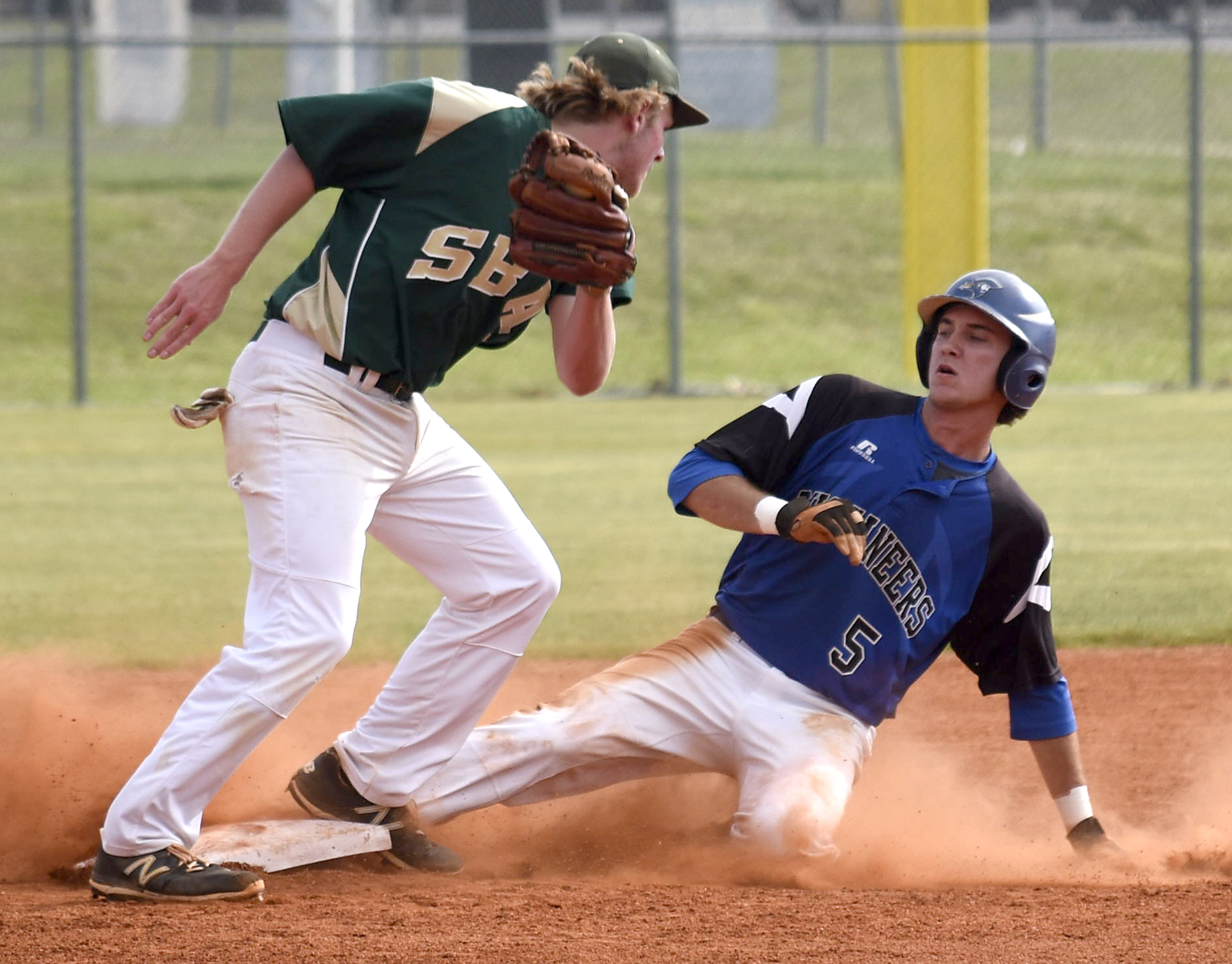 Boyd-Buchanan's Cade Evans (5) slides safely into second as Silverdale second baseman Sawyer Junkins (32) turns to make the late tag. The Silverdale Baptist Seahawks visited the Boyd-Buchanan Buccaneers in the Region 3-A championship baseball game May 18, 2016.