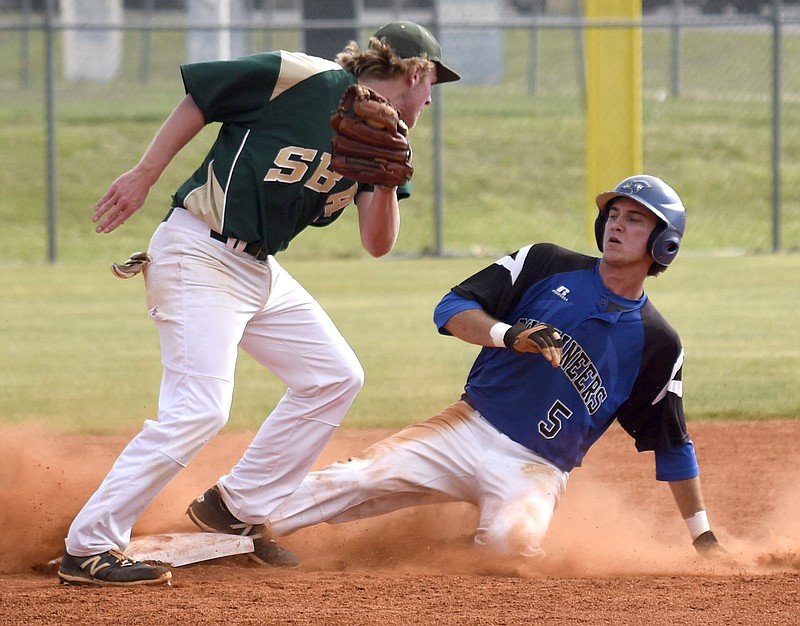 Boyd-Buchanan's Cade Evans (5) slides safely into second as Silverdale second baseman Sawyer Junkins (32) turns to make the late tag.  The Silverdale Baptist Seahawks visited the Boyd-Buchanan Buccaneers in the Region 3-A championship baseball game May 18, 2016.