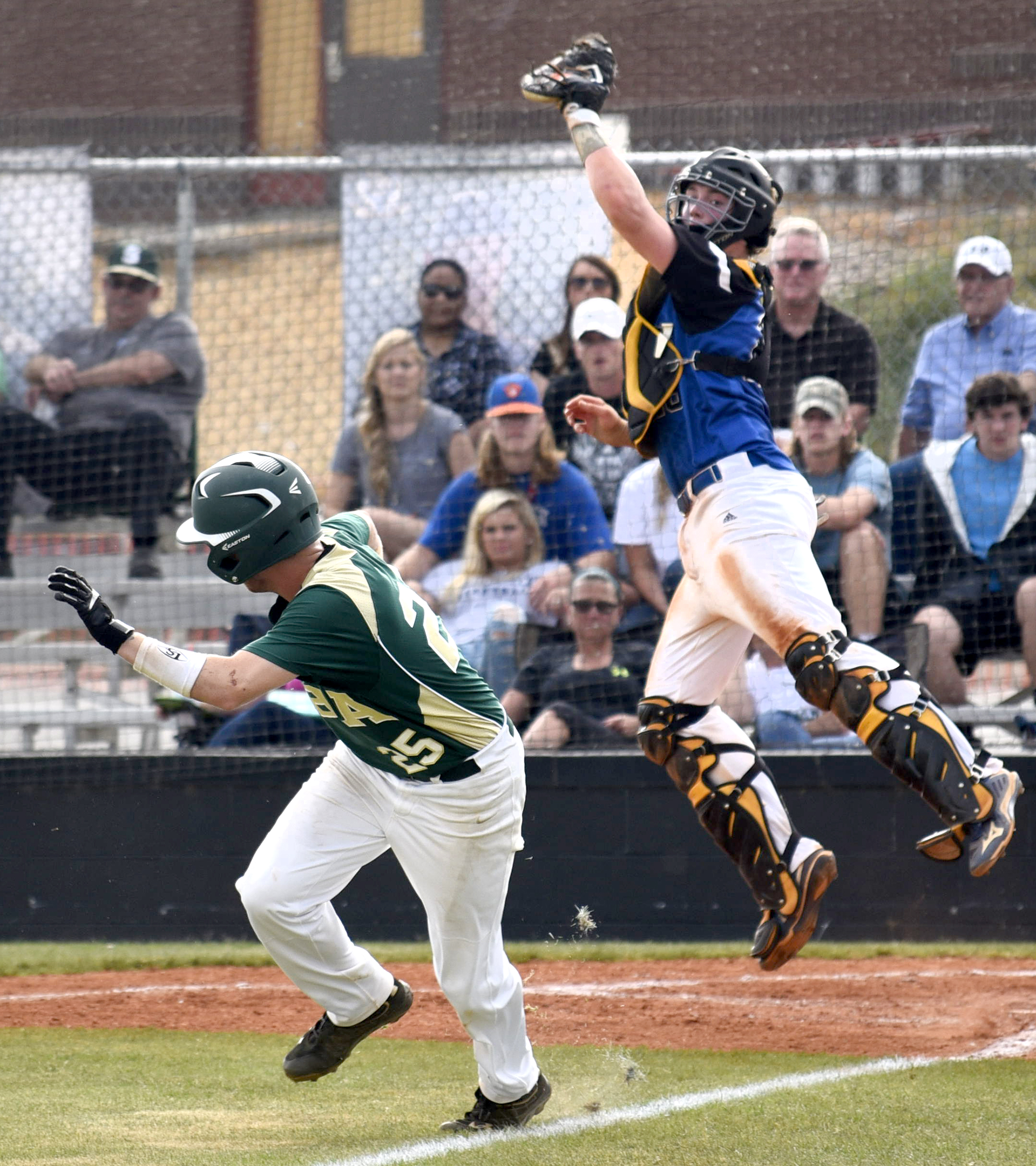 Silverdale's Collin Daniel (25) is caught in a rundown as Boyd-Buchanan catcher Cooper Hodge (28) takes the high throw. Daniel would be tagged out on the play. The Silverdale Baptist Seahawks visited the Boyd-Buchanan Buccaneers in the Region 3-A championship baseball game May 18, 2016.