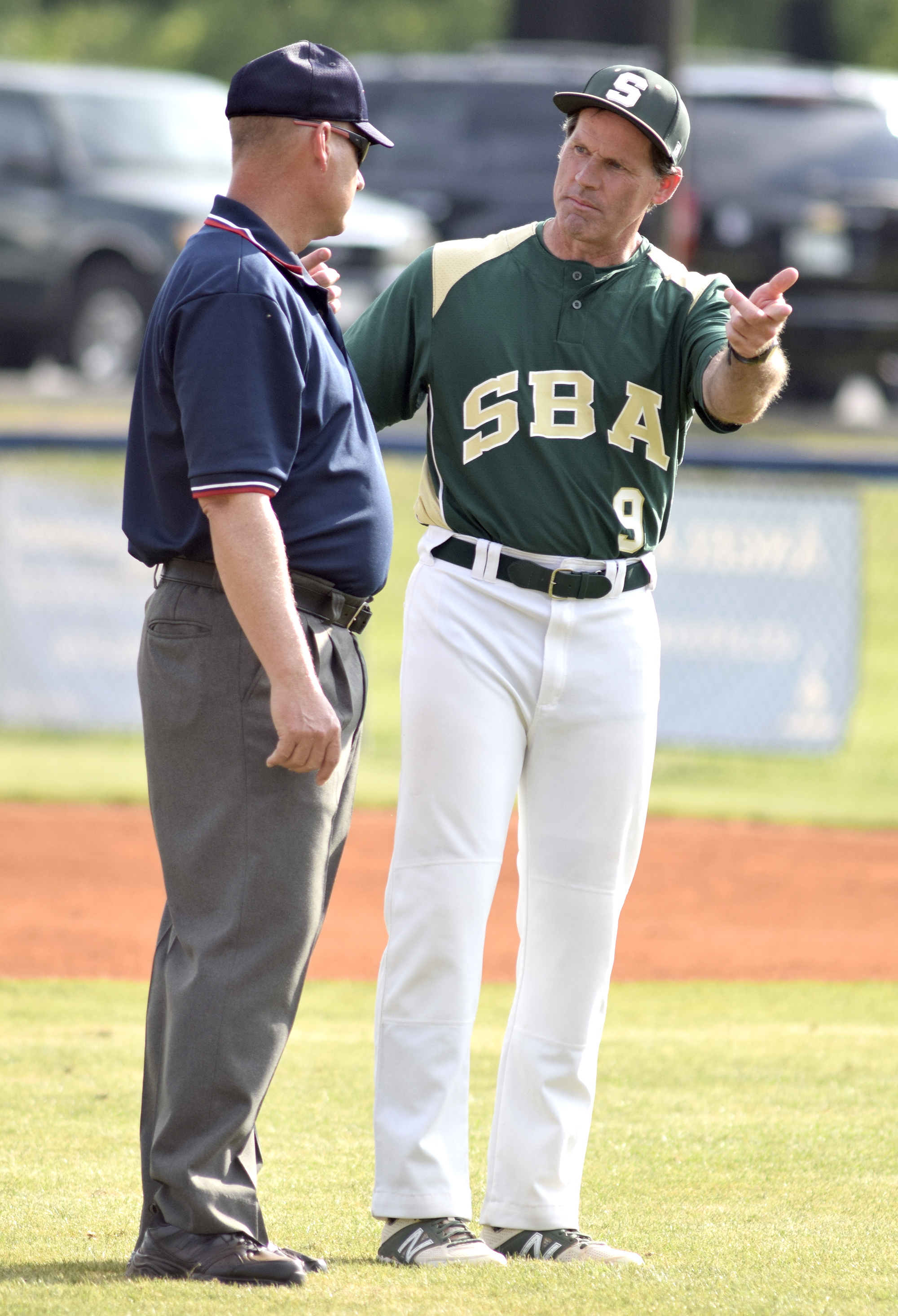 Silverdale coach Jonathan Adcock (9) discusses a call with the umpire. The Silverdale Baptist Seahawks visited the Boyd-Buchanan Buccaneers in the Region 3-A championship baseball game May 18, 2016.
