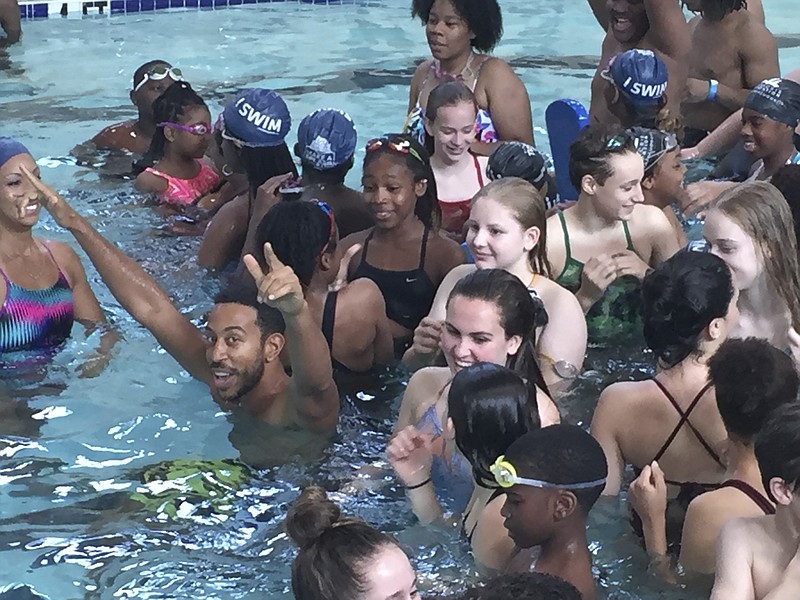 
              In this photo taken Saturday, April 30, 2016,  rapper Ludacris, gesturing at left, plays with kids during a "Make A Splash" swim lesson at the Carrie Steele-Pitts Home in Atlanta. USA Swimming hopes celebrities will help spread the message that all kids need to learn how to swim. (AP Photo/Paul Newberry)
            
