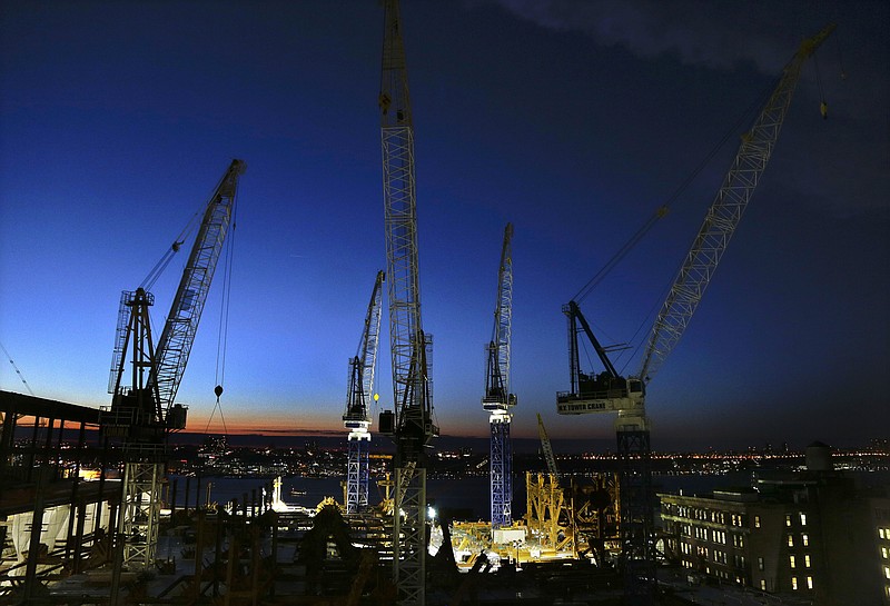 
              FILE - In this March 4, 2016, file photo, cranes move loads of materials at dusk at the Hudson Yards construction site in New York. Construction is rebounding across the United States, yet only 42 percent of adults describe the U.S. economy as good, according to a survey released Wednesday, May 18, 2016, by The Associated Press. But nearly two-thirds say their own households are faring well. That divide reflects a country sharply split by political affiliation and education level in the midst of an intensely negative presidential race. (AP Photo/Julie Jacobson, File)
            