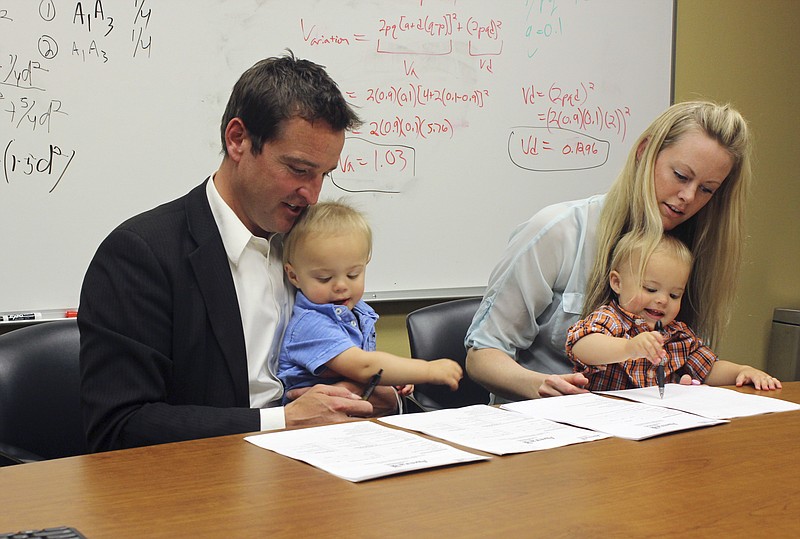 
              Craig McCarthy and Rebecca Amble read over consent forms to allow their 16-month-old identical twins, Kamper, left, and Sayers to be part of the Avera Twin Register on Wednesday, May 18, 2016, in Sioux Falls, S.D. Sioux Falls-based Avera Health on Wednesday launched the register hoping twins who live in the Midwest will contribute DNA to the project aimed at gaining insights into traits and diseases specific to the region. (AP Photo/Regina Garcia Cano)
            