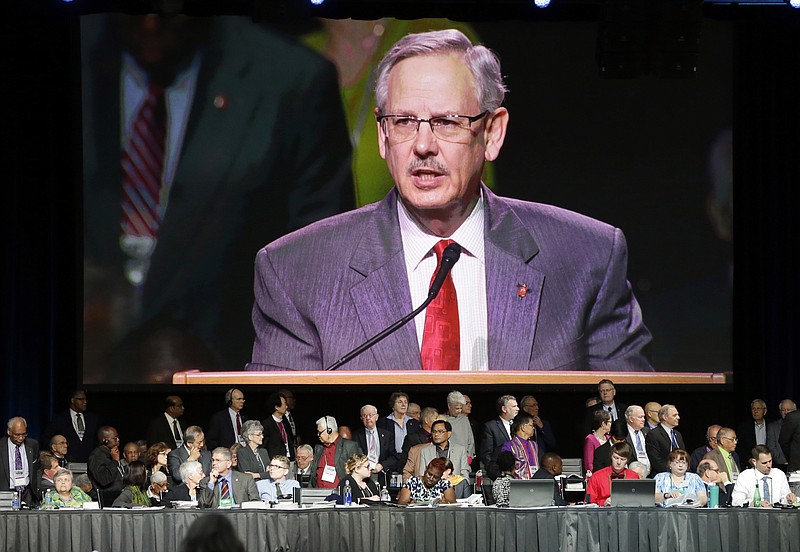 
              Bishop Bruce Ough, from the Dakotas-Minnesota church district and president of the Methodist Council of Bishops, is visible on a large monitor above attendees as he reads a recommendation regarding the churches stance on LGBT issues in Portland, Ore., Wednesday, May 18, 2016. The United Methodist Church, the nation's largest mainline Protestant denomination, is holding its once-every-four-years meeting here. It is facing a bitter fight over whether they should lift the church ban on same-sex marriage. (AP Photo/Don Ryan)
            