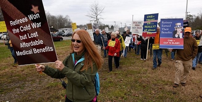 Charlene Edwards, a plaintiff in the federal lawsuit, leads about 100 retirees from Y-12 gathered along Scarboro Road to the old guard tower near the entrance to the plant to protest changes in their benefits Thursday, Dec. 4, 2014. (MICHAEL PATRICK/NEWS SENTINEL)