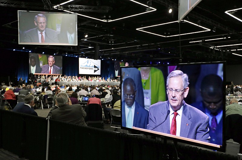 Methodist Council of Bishops President Bishop Bruce Ough is visible on multiple screens as he leads the room in prayer in Portland, Ore., Wednesday, May 18, 2016. The United Methodist Church, the nation's largest mainline Protestant denomination, is holding its once-every-four-years meeting here. It is facing a bitter fight over whether they should lift the church ban on same-sex marriage. (AP Photo/Don Ryan)