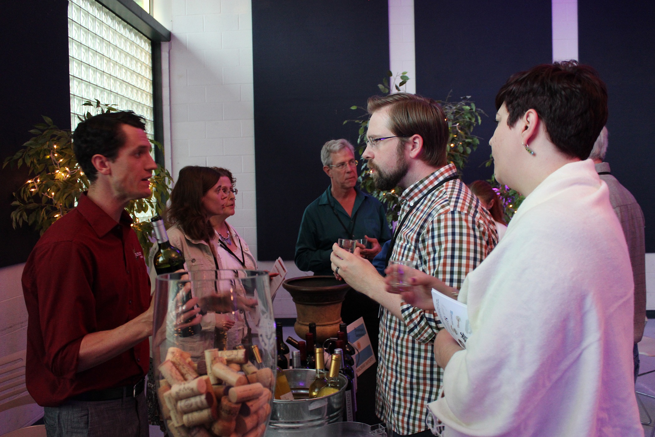 Guests enjoyed wine tasting while listening to pianist Michael Huseman. From left are Mariano Cebrian of Panoram Wine Imports with guests Preston and Wencke West.