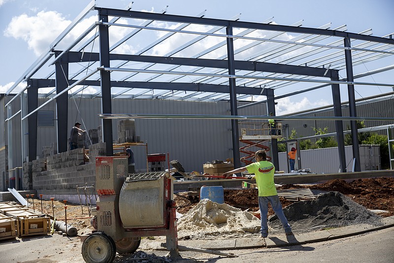 Workers cement walls as construction continues on a new warehouse and fabrication facility at Southern Fluid Power on Friday, May 13, 2016, in Chattanooga, Tenn.