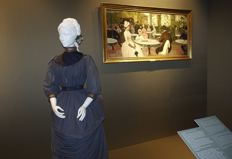 
              In this photo taken on Tuesday, May 17, 2016, a Parisian haute couture walking dress from around 1884 is pictured alongside a period painting from the Uffizi Gallery's Galleria di Arte Moderna collection depicting the fashion of the era, on display at Pitti Palace in Florence, Italy, as part of the "Across Art and Fashion'' series of exhibits at locations throughout Florence. The exhibit opened Thursday as Italy's Renaissance capital is reclaiming its centuries-old role as an incubator of the fashion-art dynamic.(AP Photo/Colleen Barry)
            