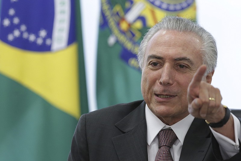 
              Brazil's acting President Michel Temer speaks during a meeting with trade unions, on the government's proposal for Social Security reform, at the Planalto Presidential Palace, in Brasilia, Brazil, Monday, May 16, 2016. Temer, Dilma Rousseff's two-time running-mate turned nemesis, immediately assumed power after her May 12 suspension and will remain while an impeachment trial takes place within the next six months. (AP Photo/Eraldo Peres)
            