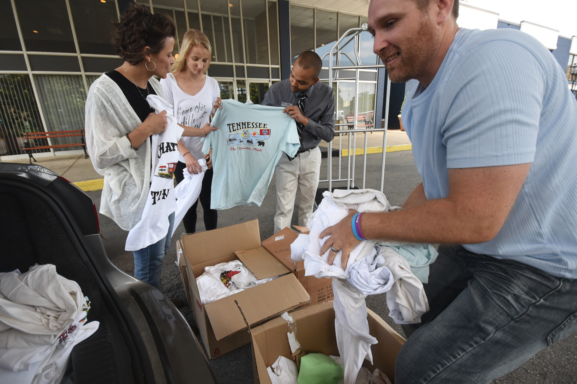 Breakaway Outreach Co-founder Jimmy Larche, right, loads donations from the Chattanooga Choo-Choo's Director of Sales Annie Still to share with Iraqi, Syrian and Sudanese refugees in Germany. In the background, Larche's wife, Cindy, left, German visitor Finni Eigenbrodt and Adam Bowerman examine the gifts.