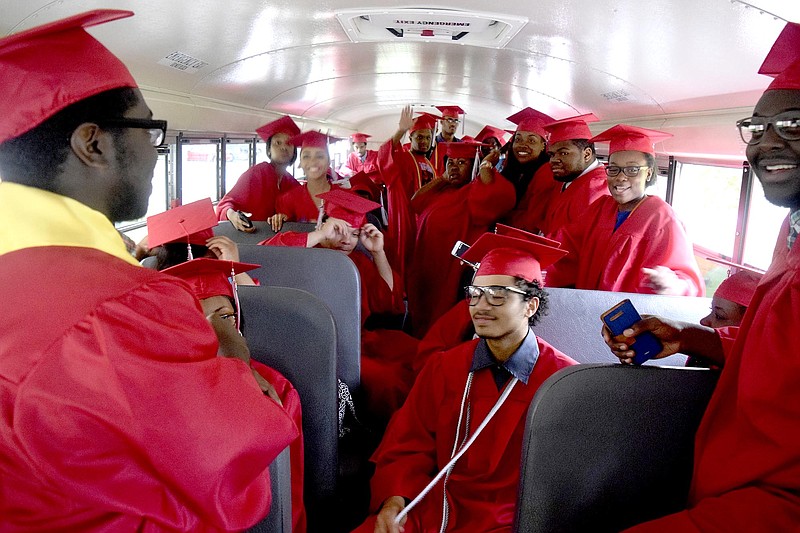 Brainerd Seniors wait on the bus prior to their entrance to Orchard Knob Elementary School.  The 2016 graduating class of Brainerd High School walked through the halls of Orchard Knob Elementary in their caps and gowns, as a representation of the "vision" for where the elementary students will one day be.  