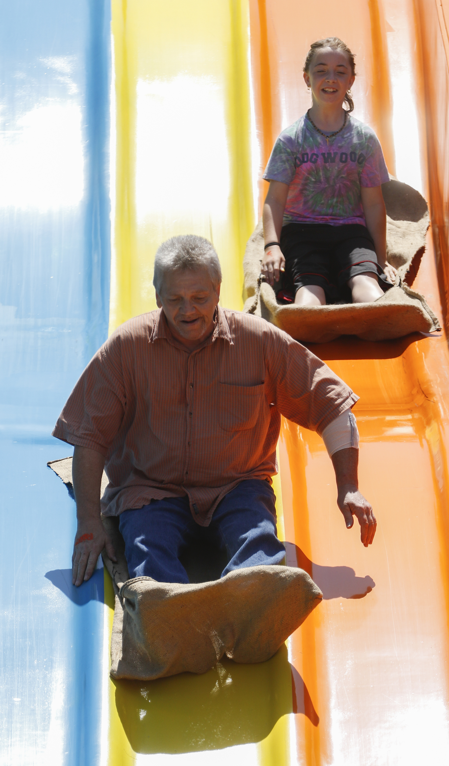 Staff Photo by Dan Henry / The Chattanooga Times Free Press- 5/19/16. Kirk Roberts rides an amusement with his 10-year-old granddaughter Anabel Roberts while at Lake Winnepesaukah Amusement Park on Thursday, May 19, 2016. Roberts took in his daughterճ three children after she was killed by Catherine Goins who wore a prosthetic baby bump lying about being pregnant and trying to steal one of NataliaRobertճ children.