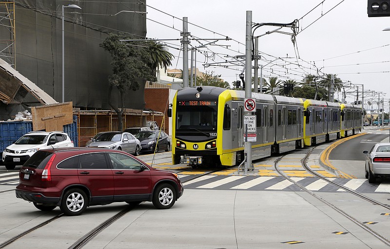 
              This Wednesday, May 18, 2016 photo shows a train approaching the new Metro Expo Line station in Santa Monica, Calif. For the first time since the 1950s, a Southern California light rail line will extend to the Pacific. Starting Friday, May 20, 2016, with the opening of the 6.6-mile extension of the Expo Line, riders can now take Metro rail from the far-inland suburb of Azusa some 40 miles to the sands of Santa Monica. (AP Photo/Nick Ut)
            