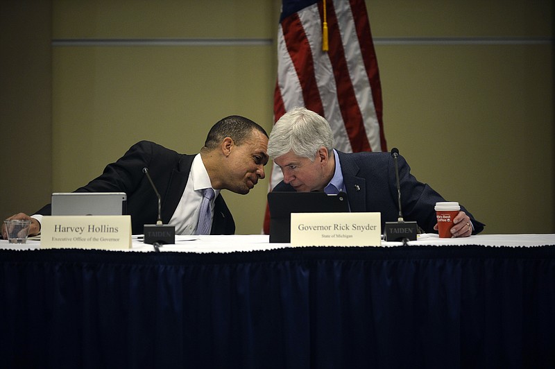 
              From left, Harvey Hollins, executive office of the Governor, speaks with Gov. Rick Snyder during the Flint Water Interagency Coordinating Committee meeting on Friday, May 20, 2016, in Flint, Mich. Snyder created a new board on Friday to eliminate children's exposure to lead statewide, saying the state needs to do more than just reduce exposure to the harmful chemical in the wake of the lead-tainted water crisis in Flint. (Rachel Woolf/The Flint Journal-MLive.com via AP) MANDATORY CREDIT
            