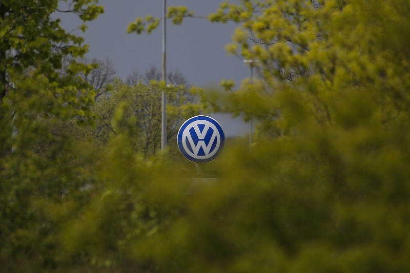 
              FILE - In this April 28, 2016 file photo a Volkswagen emblem VW at a factory entrance stands behind green bushes in Wolfsburg, Germany. Automaker Volkswagen and Germany's industrial union have agreed Friday, May 20, 2016, to increase wages 4.8 percent by next year in an economy where the cost of living is flat — the kind of raises that could help the 19-country eurozone lift inflation from dangerously low levels. (AP Photo/Markus Schreiber, file)
            