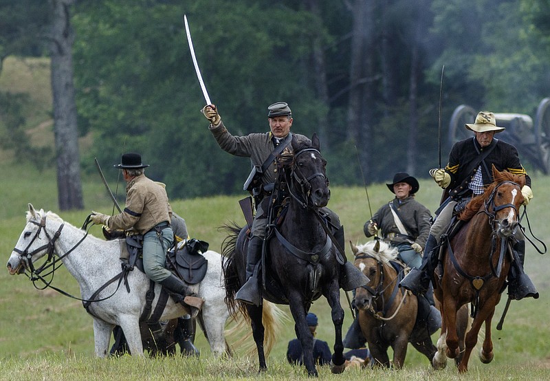 Cavalry reenactors charge during the Battle of Resaca Reenactment on Saturday, May 21, 2016, in Resaca, Ga. The annual reenactment showcases a battle fought in May of 1864 in the Atlanta Campaign of the Civil War.