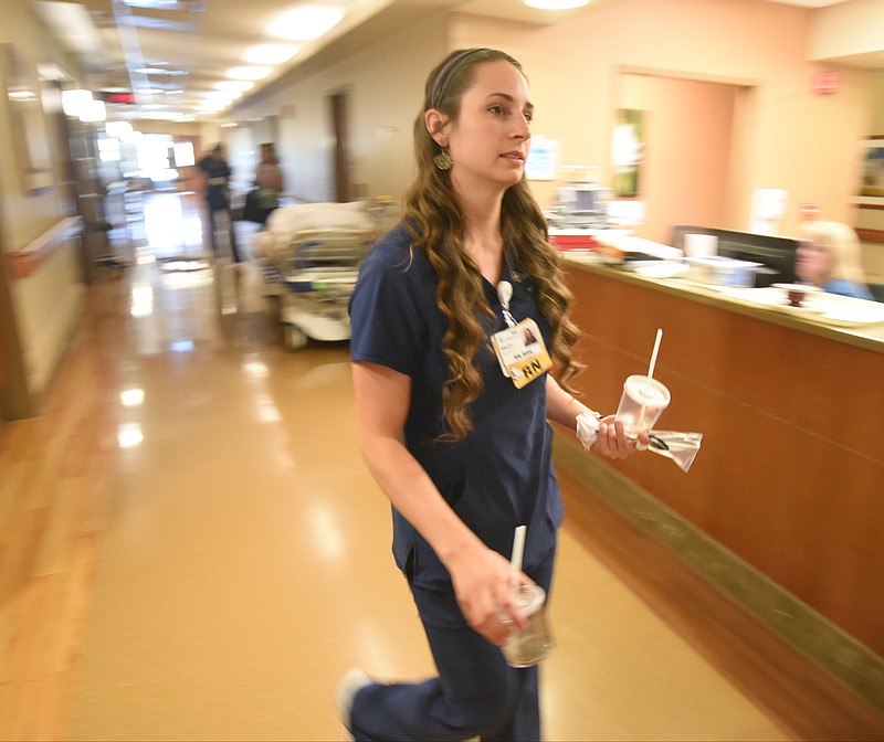 Haley McKinney carries used food items for disposal in the Guerry Heart and Vascular Center at CHI Memorial.