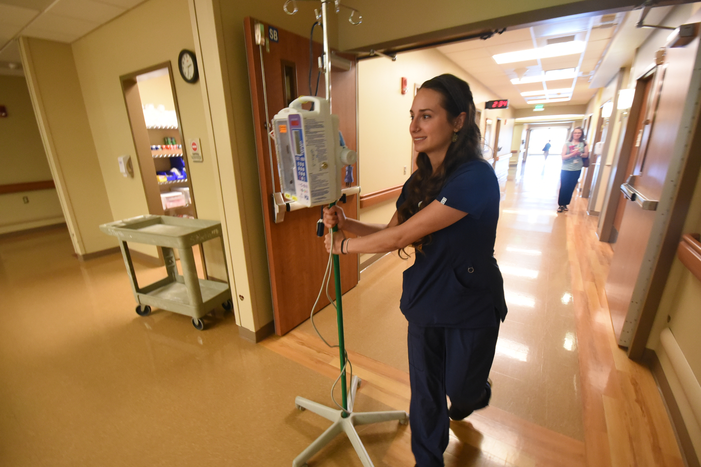 Haley McKinney, RNBSN at CHI Memorial, rolls an IV pole toward a patient room in the Guerry Heart and Vascular Center at CHI Memorial.