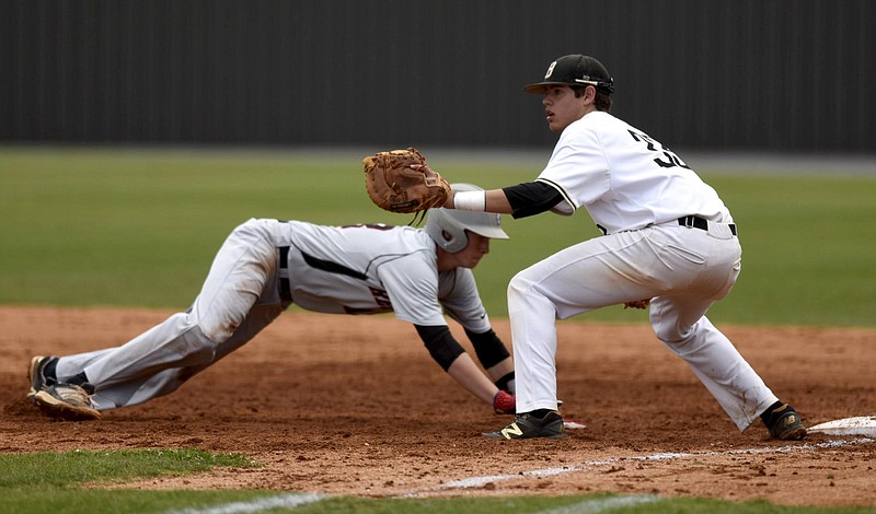 Stewarts Creek's Brandon Dial (13) gets back to first as Bradley Central's Gunnar Norwood (33) takes the attempted pickoff throw.  The Stewarts Creek Red Hawks visited the Bradley Central Bears in a TSSAA Sectional baseball matchup Saturday May 21, 2016.