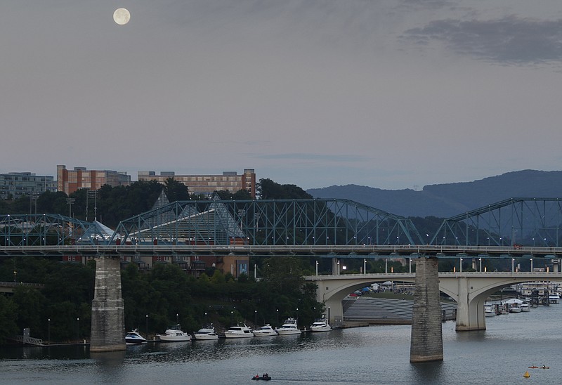 Staff Photo by Dan Henry / The Chattanooga Times Free Press- 5/22/16. Competitors wait for sunrise to begin the 2016 Sunbelt Bakery Ironman 70.3 event in downtown Chattanooga on Sunday, May 22. 