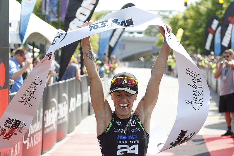 Heather Jackson, from Bend, Ore., celebrates her win in the women's race at Sunday's Ironman Chattanooga 70.3.