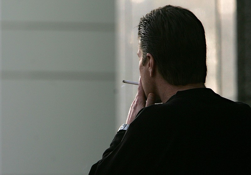 
              FILE - In this Dec. 13, 2005, file photo, an unidentified man smokes a cigarette in Sacramento, Calif. The adult smoking rate fell in 2015, with its largest annual decline in at least 20 years, according to a new government report. (AP Photo/Rich Pedroncelli, File)
            