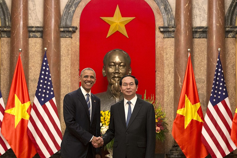 
              U.S. President Barack Obama, left,  and Vietnamese President Tran Dai Quang shake hands at the Presidential Palace in Hanoi, Vietnam, Monday, May 23, 2016. The president is on a weeklong trip to Asia as part of his effort to pay more attention to the region and boost economic and security cooperation. (AP Photo/Carolyn Kaster)
            