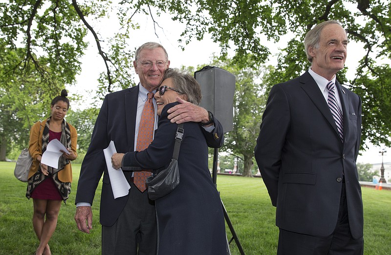 
              Sen. Barbara Boxer, D-Calif., embraces Senate Environment and Public Works Committee Chairman Sen. James Inhofe, R-Okla., on Capitol Hill in Washington, Thursday, May 19, 2016, during a news conference to discuss bipartisan legislation to improve the federal regulation of chemicals and toxic substances. Sen. Tom Carper, D-Del. is at right. (AP Photo/J. Scott Applewhite)
            