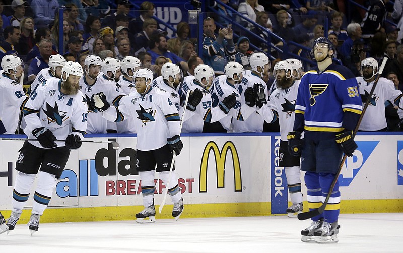 San Jose Sharks center Joe Pavelski (8) celebrates with teammates after scoring a goal during the second period in Game 5 of the NHL hockey Stanley Cup Western Conference finals Monday, May 23, 2016, in St. Louis. At right is St. Louis Blues defenseman Colton Parayko (55).