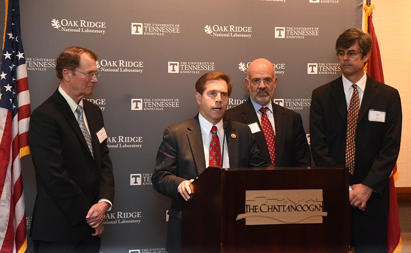 Chuck Fleischmann, R-Tenn., speaks as Dr. Franklin Orr, University of Tennessee President Joe DiPietro and Thom Mason, from left, listen during a press conference at a regional energy innovation conference May 23, 2016, at the Chattanoogan.