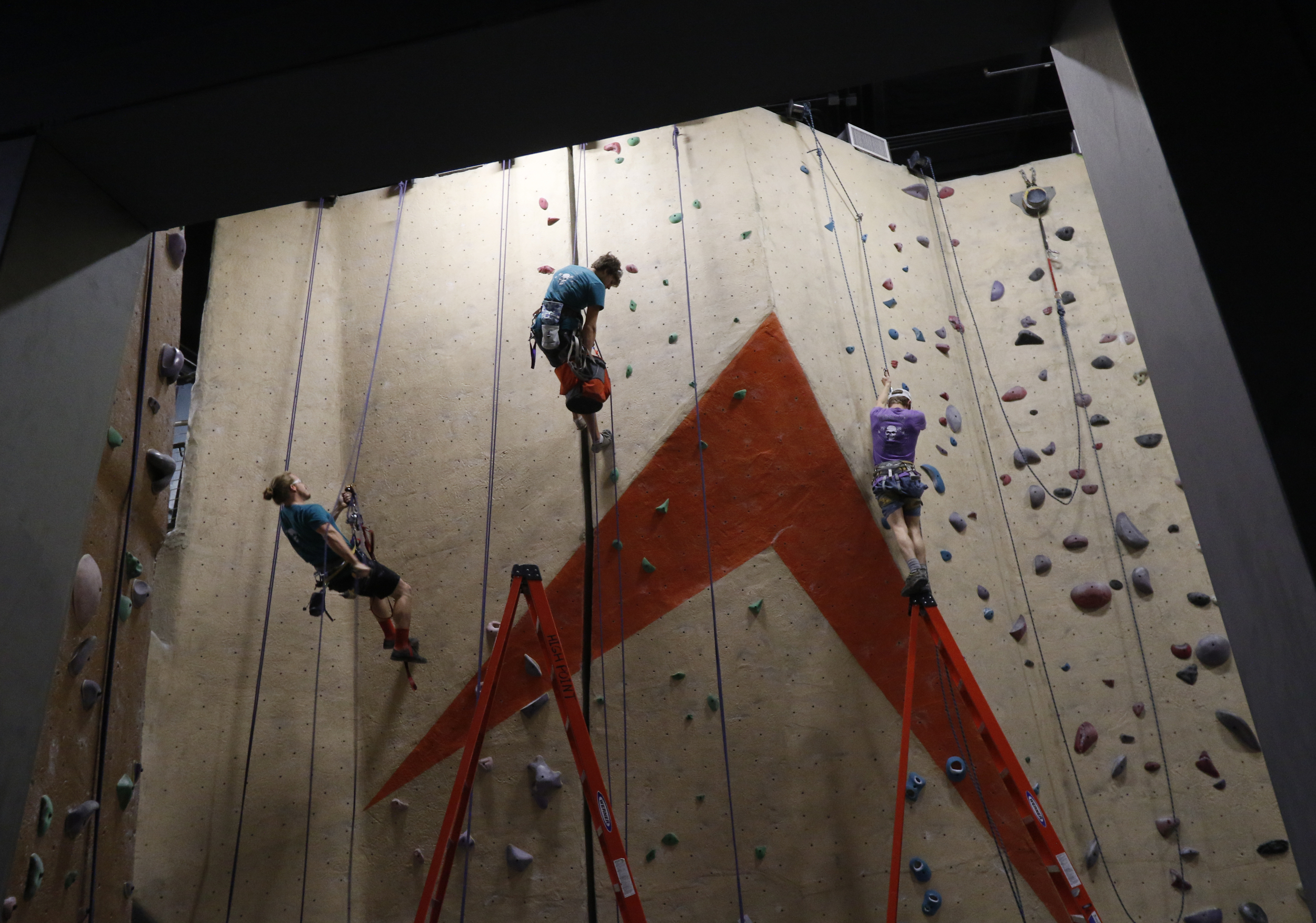 Staff Photo by Dan Henry / The Chattanooga Times Free Press- 5/19/16. Cody Grodzki, the director of route setting for High Point Climbing and Fitness, Johathan Gallagher and Andy Cutler, from left, reset the top rope room on May 19, 2016.